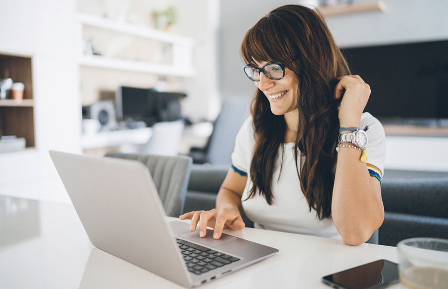 Eine junge Frau sitzt am Laptop