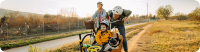 Eine junge Familie fährt zusammen mit Ihrem Hund Fahrrad.